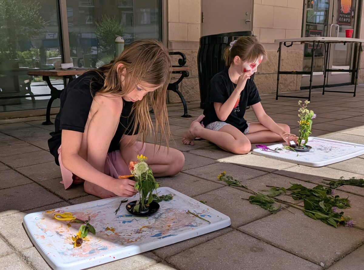 2 girls with Japanese face paint doing an outdoor plant-based activity at Potomac Kempo Summer Camp 2026